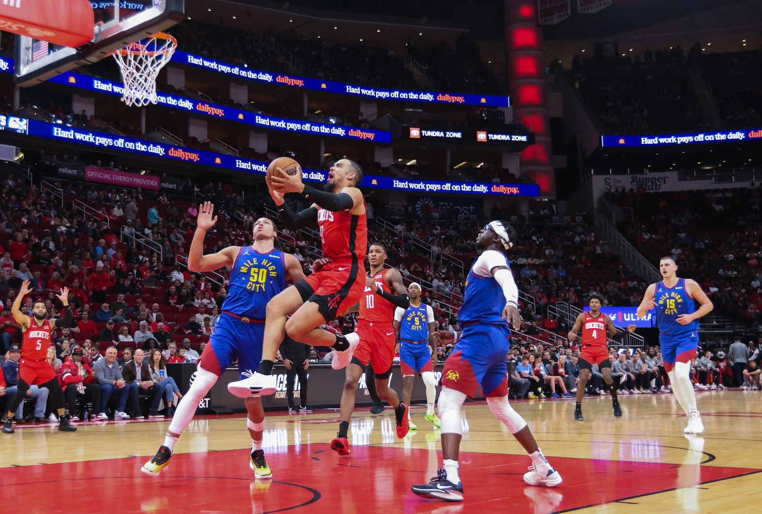 Rockets forward Dillon Brooks drives against Denver Nuggets forward Aaron Gordon (50) in the first quarter at Toyota Center.